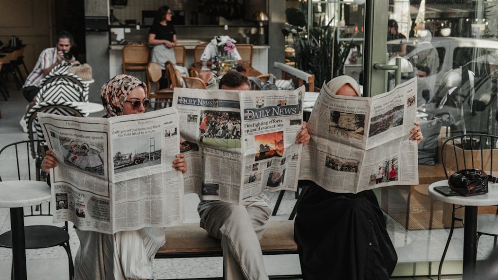 group of people reading newspaper